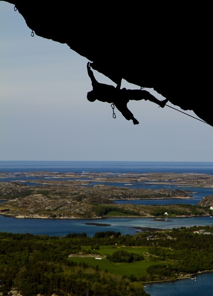 Magnus Midtbö climbing high above the fjords at Flatanger in Norway.