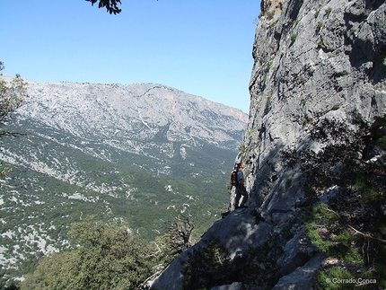 Tiscali, Sardinia - A walker climbing up to Monte Tiscali enjoys broad views over the Supramonte
