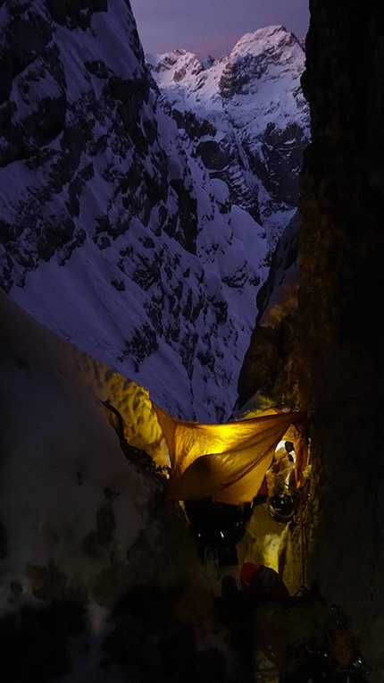 Triglav, Slovenia - Triglav North Face: Matevž Mrak and Matevž Vukotic at the second bivy during the winter ascent of the routes Prusik - Szalay and Obraz Sfinge, carried out from 23 - 26 December 2014
