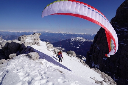 Davide Sassudelli paraglides off Campanile Basso in Brenta Dolomites