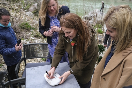 Vjosa, Albania - Minister of Tourism and Environment Mirela Kumbaro Furxhi signs a rock to commemorate the declaration of Vjosa Wild River National Park