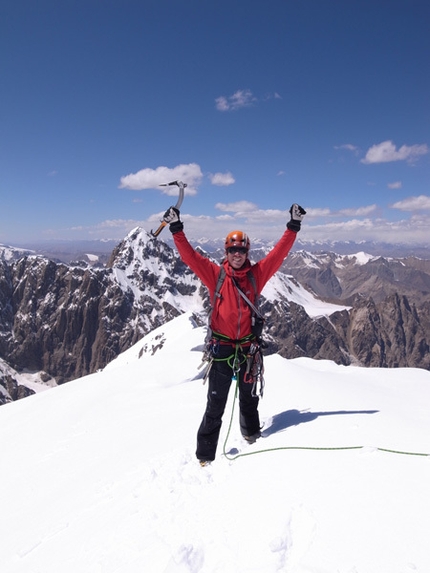 Kyrgyzstan - Kristoffer Szilas on the summit of Peak Alexandra with the still unclimbed Pt 5318 in the background.