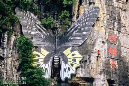 Yangshuo, China - Simon Wilson climbing a 5.10b sport route at the 'Butterfly Spring' tourist attraction near Yangshuo, China.