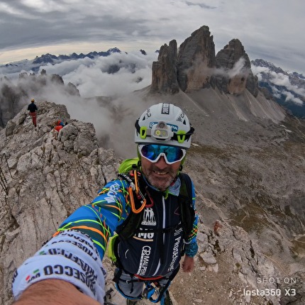 Tre Cime di Lavaredo, Dolomites - Moreno Pesce on the summit of Monte Paterno, with Tre Cime di Lavaredo in the background
