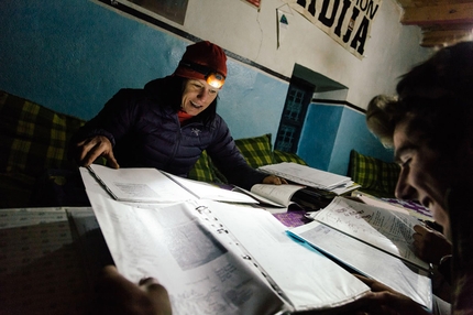 Ines Papert, Lisi Steurer, Patrik Aufdenblatten, Tadrarate, Taghia, Morocco - April 2013: Studying the route topos in the Gîtes run by Youssef Riziki