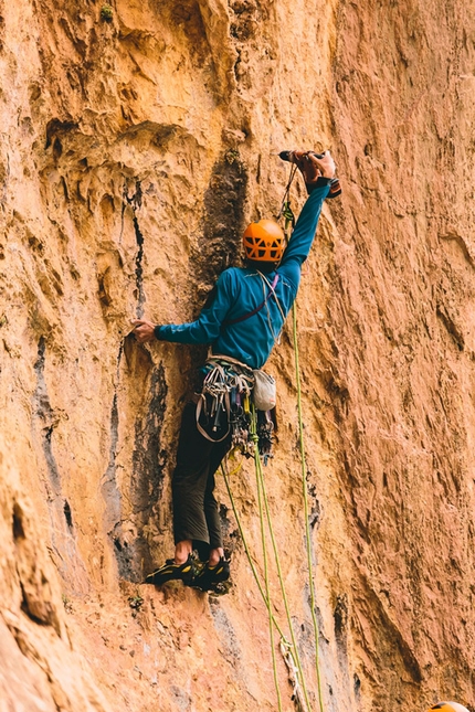 Ines Papert, Lisi Steurer, Patrik Aufdenblatten, Tadrarate, Taghia, Morocco - April 2013: Patrik Aufdenblatten bolting the first pitch