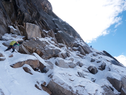 Mt Dayantianwo, Shuangqiao, China - Chaohui Zheng traversing mixed terrain near the base of the wall while climbing Three Sheep Bring Prosperity (600m, 5.10 r/x, 60°, Dave Anderson, Chaohui Zheng, Szu-ting Yi) Mt Dayantianwo, Siguniang National Park, China.