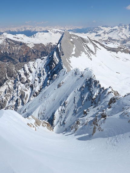 Sas dles Diesc, Fanes, Dolomites - Simon Kehrer and Roberto Tasser on 14/04/2014 skiing down Sasso delle Dieci: the starting gully close to the cross, with splendid view onto Sas dles Nü, Cima Nove