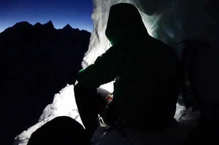 Mt Dickey, Alaska - Mt Dickey, Alaska:  Chad Diesinger belaying Jason Stuckey (out of the frame). As soon as we had enough light in the sky to start climbing (Day 2: March 21) we immediately abandoned our snow cave mostly as an opportunity to start generating some heat and warm up slowly. Unfortunately the first pitch out of the cave was one of the deepest, unconsolidated snow pitches of the entire route and it required hours to lead. While Jason warmed up trenching his way up the mountain Chad and John courted hypothermia.