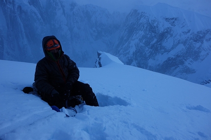 Mt Dickey, Alaska - Mt Dickey, Alaska: After summiting we almost immediately began our descent down the West Ridge of Dickey to take advantage of the light to speed our descent. We nearly reached the 747 pass just before dusk and decided to enjoy a brew stop before the cold of the night. At this point we had more or less been on the go and awake for 41 hours. Photo of Jason Stuckey enjoying a brief respite.