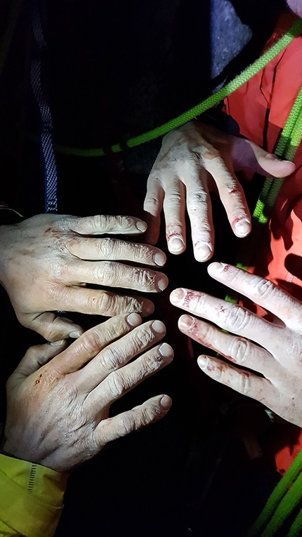 Grand Capucin, Mont Blanc, L'or du temps, Pavel Kratochvíl, Róbert Luby, Martin Krasňanský - The hands of Pavel Kratochvíl, Róbert Luby and Martin Krasňanský after first free ascent of 'L'or du temps', Grand Capucin, Mont Blanc