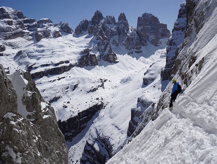 Brenta Dolomites - Luca Dallavalle skiing down the NE Face of Crozzon di Val d'Agola in the Brenta Dolomites. From left: Cima Brenta, Spallone Massodi, Torre di Brenta, Sfulmini, Campanil Alto, Campanil Basso, Cima Brenta Alta