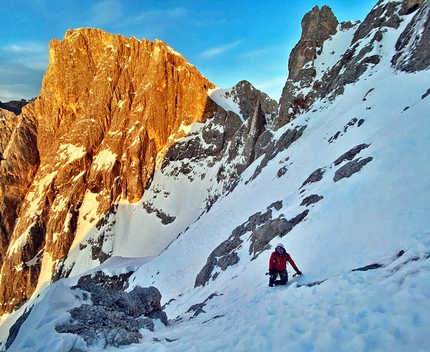 Cimon della Pala, Pale di San Martino, Dolomites, Emanuele Andreozzi, Matteo Faletti - Emanuele Andreozz in descent with Cima Vezzana in the background, after the first ascent of Elements of Life on the north face of Cimon della Pala, Pale di San Martino, Dolomites