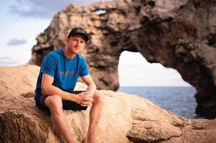 Jakob Schubert - 30-year-old Austrian climber Jakob Schubert on Mallorca. Es Pontas, the most difficult deep water solo on the island, can be seen in the background