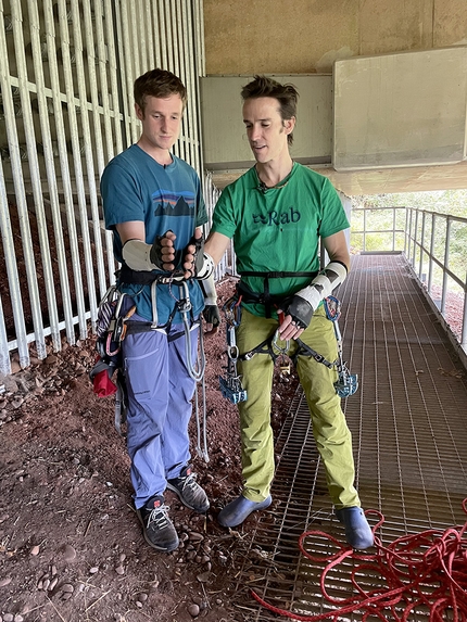 Tom Randall, Pete Whittaker, motorway bridge  - Pete Whittaker and Tom Randall comparing hand sizes at the start of their ascent of the huge M5 motorway bridge