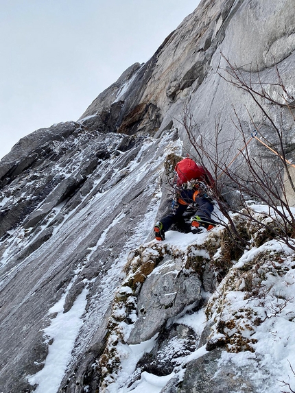 Entropi, Blokktind, Norway, Juho Knuuttila, Eivind Jacobsen - Juho Knuuttila leading on turf low on the face while making the first ascent of Entropi on Blokktind in Norwa