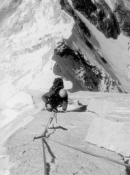 Changabang West Wall - Peter Boardman coming up the steep granite wall on the West Wall of Changabang. Camp 1 is the small dot on the left of the ridge below. 