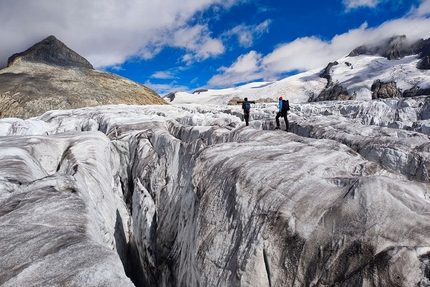 Glaciers in Switzerland - Glaciologists out taking measurements in the labyrinth of crevasses at the Rhone Glacier (Valais).