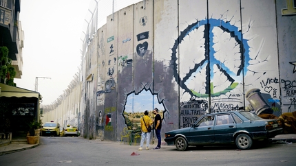 Reel Rock - Resistance Climbing: Faris Ag shows Andrew Bisharat the Separation Wall in east Jerusalem.