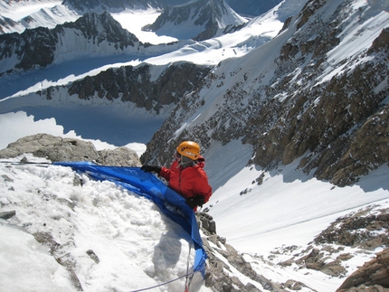 Sasser Kangri II - Filling the Ice Hammock with snow to build up a bivy ledge